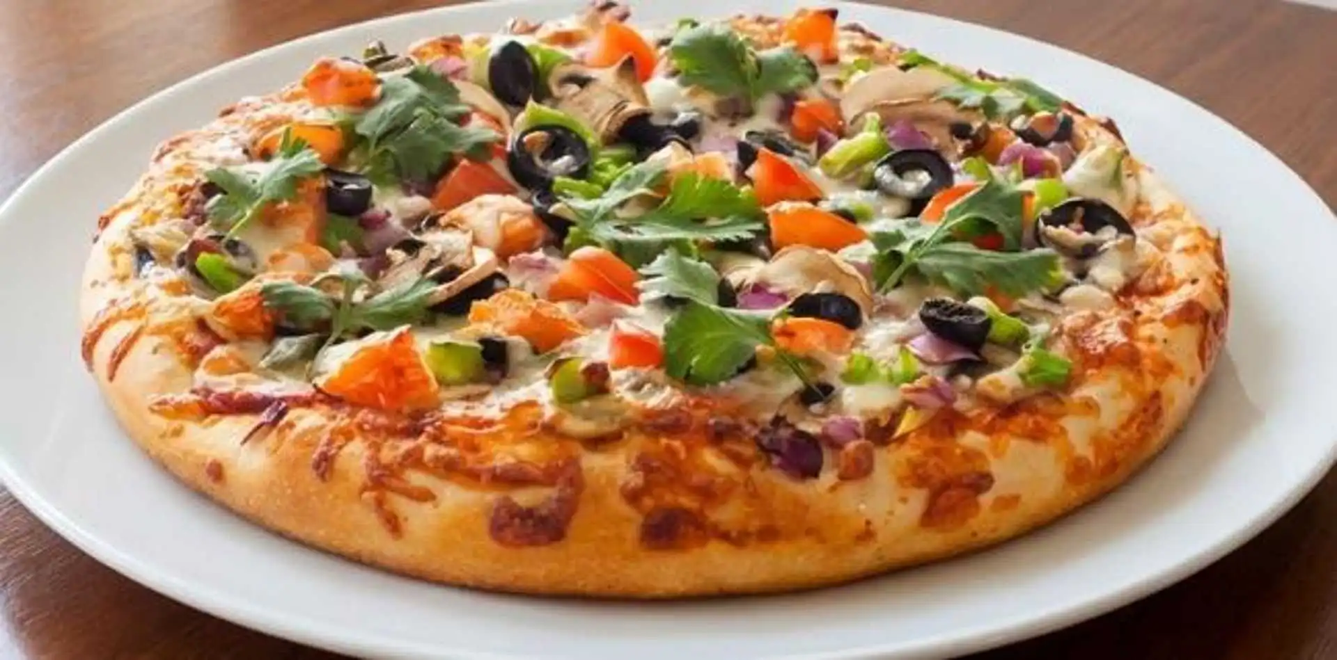 Desi Pizza at Chicago Deep Dish Pizza 32 Street NE Calgary - customer favorite blending Chicago-style with unique flavors